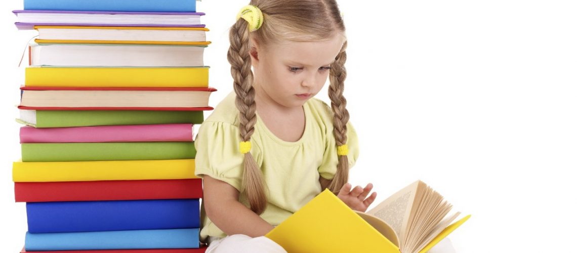 Little girl reading  pile of books. Isolated.